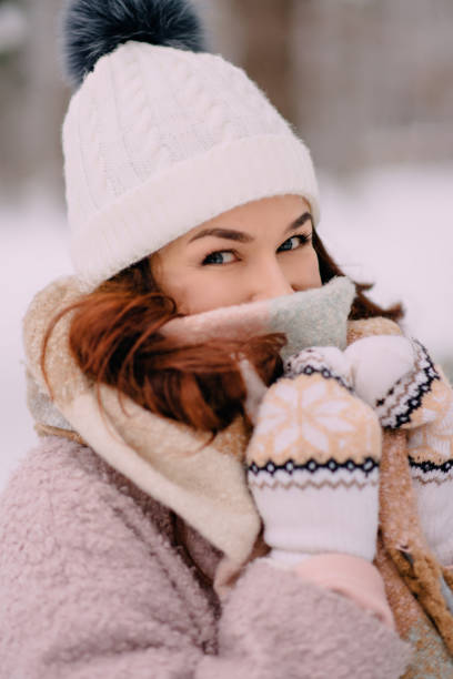 istock female covers her face from cold in snowy woods 1086270380