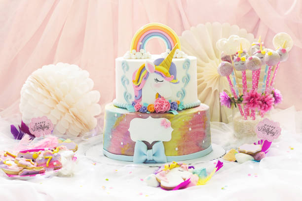 little girl's birthday party; dessert table with unicorn cake, cake-pops, sugar cookies and birthday decoration - little cakes imagens e fotografias de stock