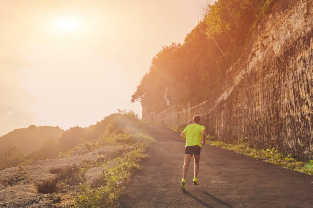 istock Jogging on a uphill / downhill remote road. 1086275928