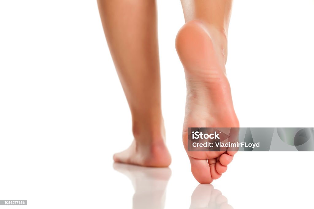 Back View Of Woman Foot On White Background, Close-up Stock
