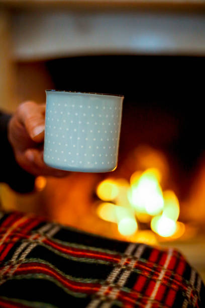 istock Mature man near fireplace drink coffee 1086280592