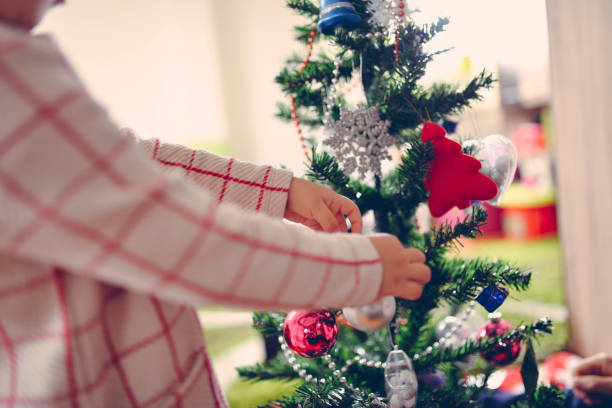 istock Girl decorating the Christmas tree in home 1086304188