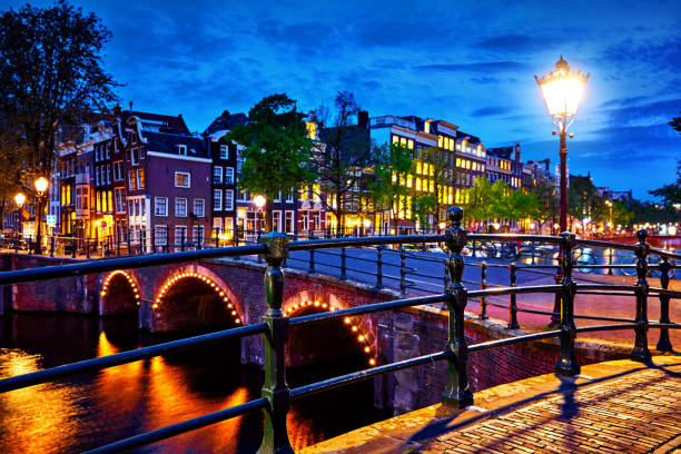 istock Amsterdam, Netherlands. Bridges with nighttime illumination 1086310718