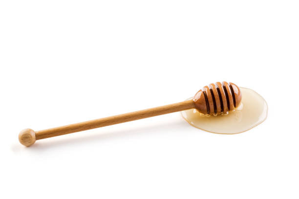 istock Honey and honey dipper on white background 1086313496