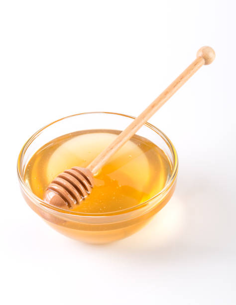 istock Honey with dipper and flowing honey 1086313598