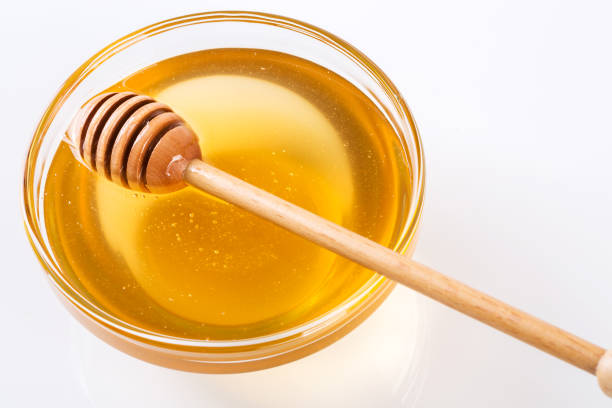 istock Stick with honey isolated on white 1086313760