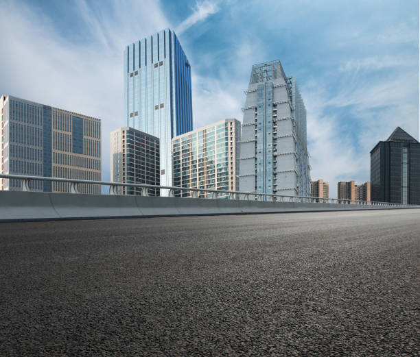 istock Overpass, asphalt pavement and modern architecture    Urban road surface background 1086318244