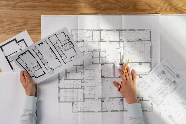 istock High angle above top view cropped lady in her formalwear shirt she analyzing expertise inspect read prepare technical property sit at the desk in light loft interior hold lank in hand 1086321514