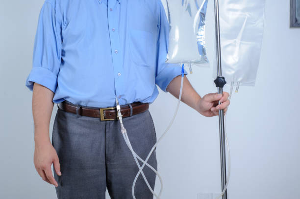 Peritoneal Dialysis user with catheter and saline bag Peritoneal Dialysis user with catheter and saline bag peritoneal dialysis photos stock pictures, royalty-free photos & images