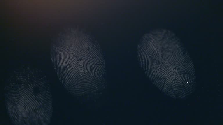 A person leaves his fingerprints on a dark surface