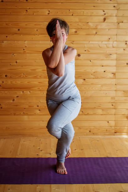 istock Caucasian woman is practicing yoga at studio 1086326698