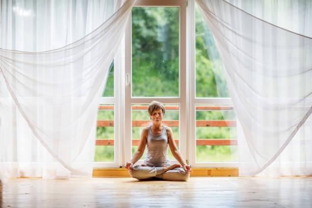 istock Caucasian woman is practicing yoga at studio 1086326802