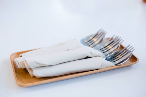 istock Spoon and fork wrapped in tissue paper on a wooden tray 1086329168
