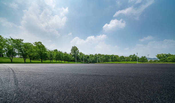 Empty Parking Lot Horizon over Parking Lot empty road with trees stock pictures, royalty-free photos & images