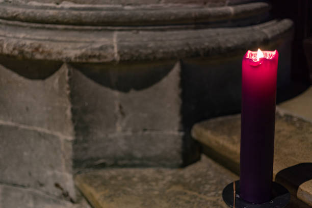 istock violet candle in church at advent christmas time 1086330642