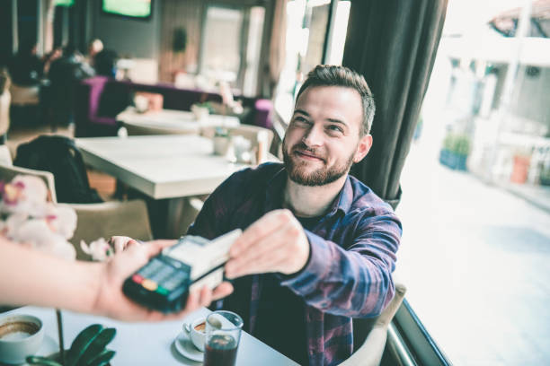 istock Young Handsome Male Pays With Contactless Method 1086330718