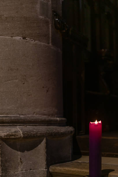 istock violet candle in church at advent christmas time 1086330912