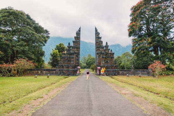 istock Woman with tradition Balinese architecture in Bali 1086337090