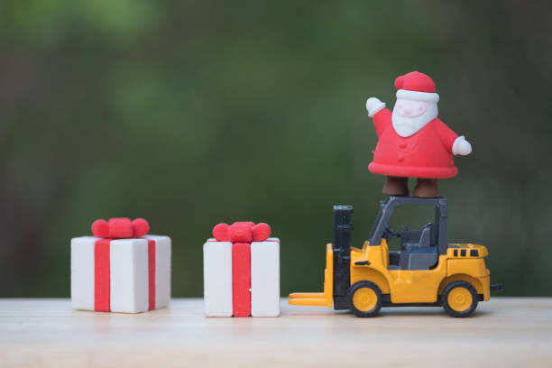istock Santa standing on yellow forklift loading gift box ready sent to children in Christmas, happy time concept 1086339220