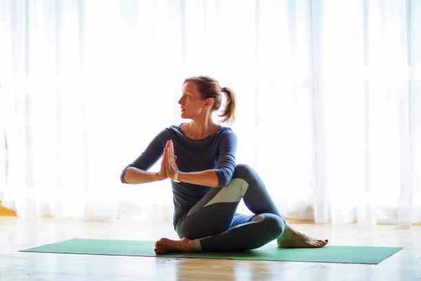 istock Caucasian woman is practicing yoga at studio 1086343650