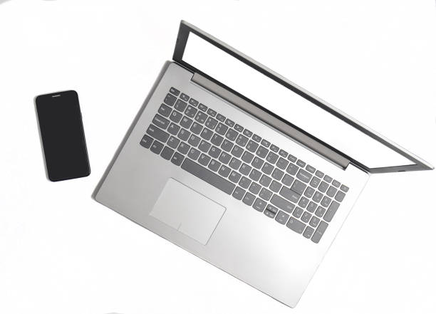 istock Laptop and frameless phone on a white background. Modern technological gadgets, white screens for copy space 1086350016