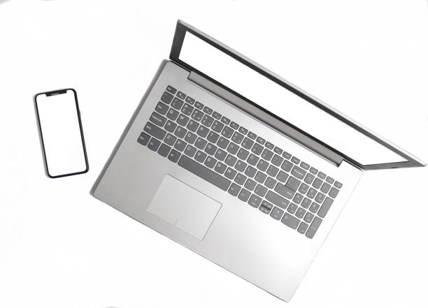 istock Laptop and frameless phone on a white background. Modern technological gadgets, white screens for copy space 1086350018