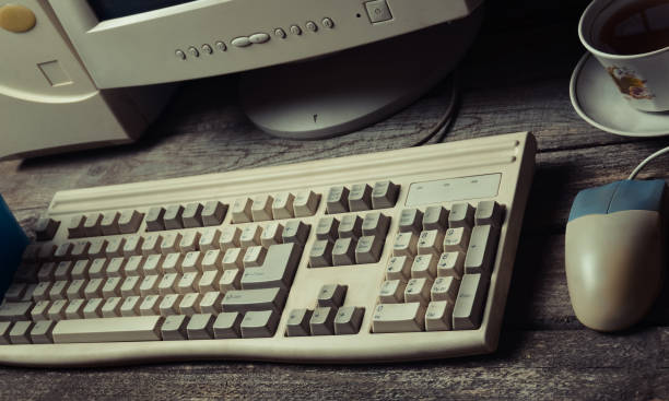 istock Retro stationary computer on a rustic wooden table, vintage workspace, top view, flat lay 1086350154
