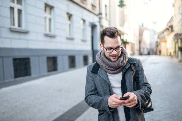 istock Young entrepreneur walking in the city, using smartphone. 1086350662
