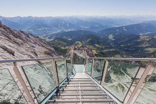 Steps to a hanging lookout of alpine landscape seen from Dachstein glacier, Austria
