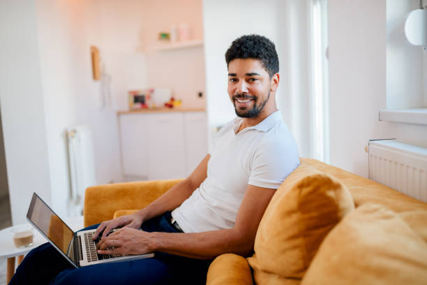 istock Smiling freelancer working on laptop at home, looking at camera. 1086351006