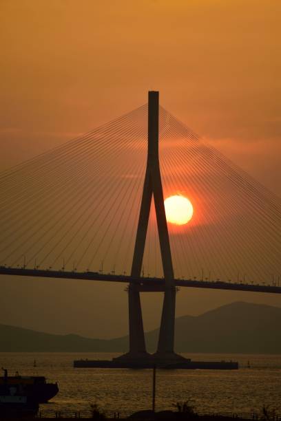 istock Sun Beyond Suspension Bridge Cables - III 1086352560