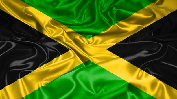 istock Jamaican flag on silk and satin texture with mask and displace technique 1086352676