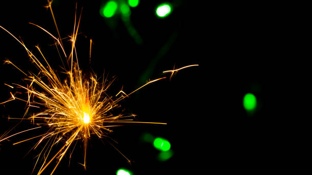istock burning sparkler on bokeh background from lights of garland 1086353676