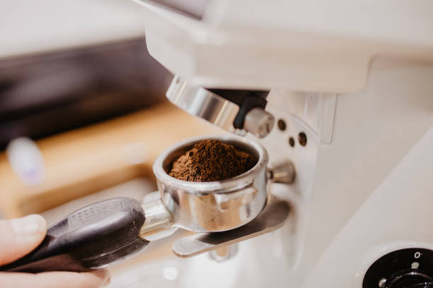 istock Barista grinding coffee beans using coffee machine, coffee grinder grinding freshly roasted make beans into powder. 1086360042