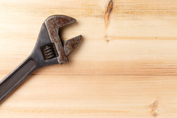 istock Old, rusty adjustable wrench on wooden background. Top view. Flat lay. Copy space. Close-up 1086363760