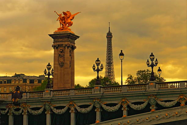 Eiffel Tower from Pont Alexandre III at sunset – Paris, France The Pont Alexandre III, from 1892, is a deck arch bridge that spans the Seine in Paris. It connects the Champs-Élysées quarter with those of the Invalides and Eiffel Tower.