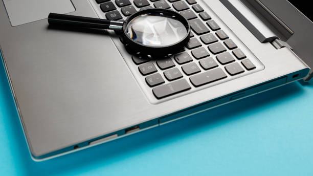 istock Laptop computer with magnifying glass on blue background, concept of search. Internet security conceptual image 1086367566