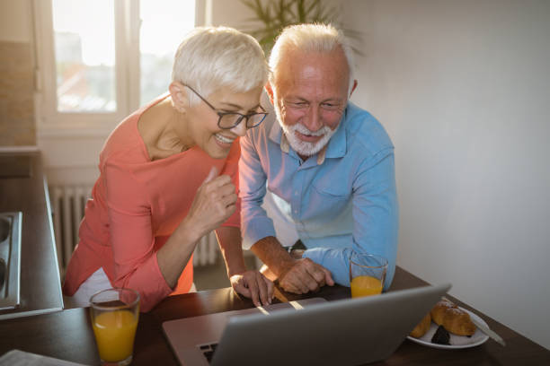 istock Cheerful senior couple surfing the internet 1086367584