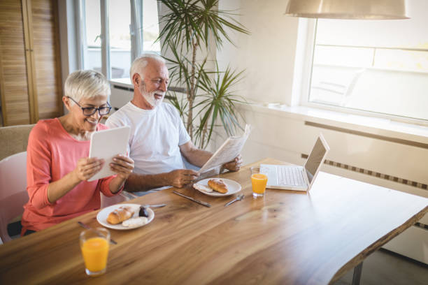 istock Senior couple reading news during breakfast 1086367674