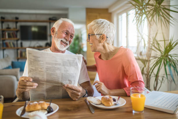 istock Senior couple reading newspaper jokes 1086367680