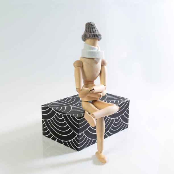 istock a wooden puppet with scarf and cap 1086370884