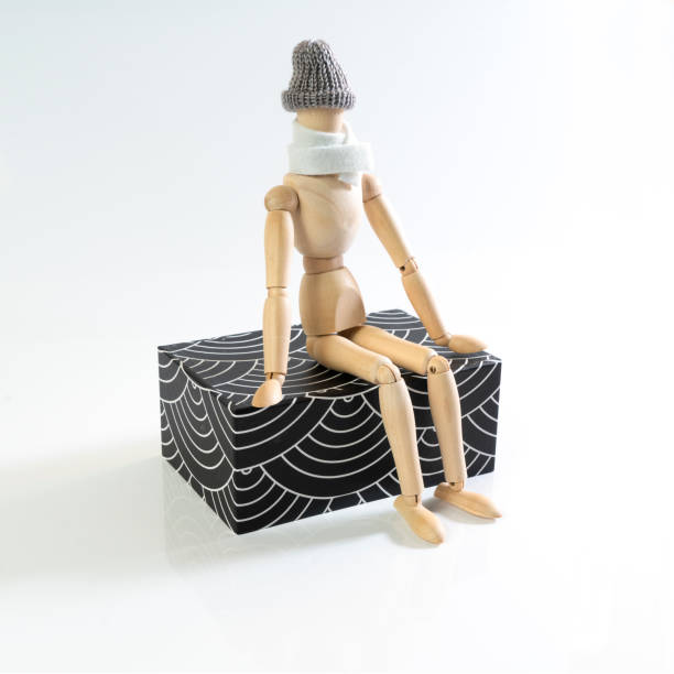 istock a wooden puppet with scarf and cap 1086370888