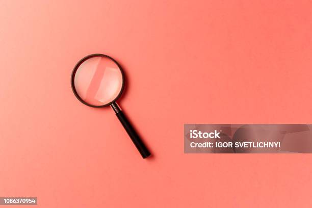 Magnifying Glass On Coral Background Top View Flat Lay Copy Space New Minimal Creative Concept Living Coral Color Of The Year 2019 Stock Photo - Download Image Now