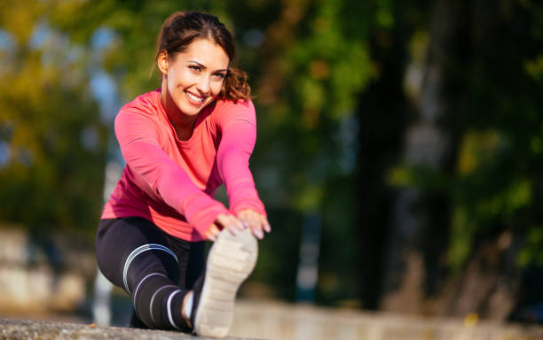 istock Young happy woman athlete stretching legs before morning workout 1086371036
