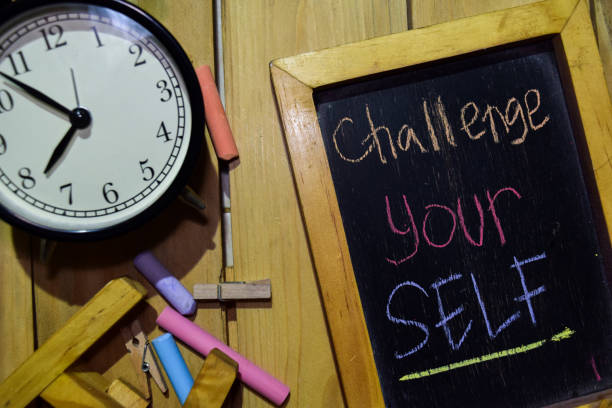 istock Challenge yourself on phrase colorful handwritten on chalkboard 1086376514