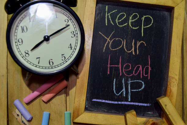 istock Keep Your Head Up on phrase colorful handwritten on chalkboard 1086376578