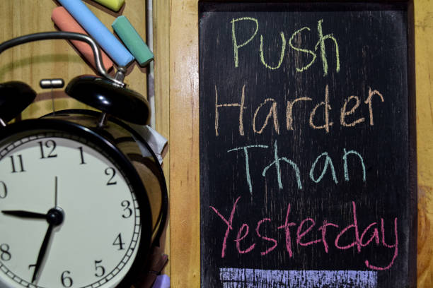 istock Push Harder Than Yesterday on phrase colorful handwritten on chalkboard 1086377786