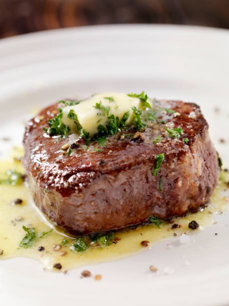 bistecca di filetto medio raro mignon con burro all'aglio alle erbe - beef close up cooked dinner foto e immagini stock