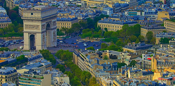 Arc de Triomphe and French roofs architecture from above at sunset – Paris, France