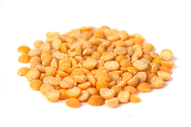istock yellow split peas isolated on white background, healty food 1086379200